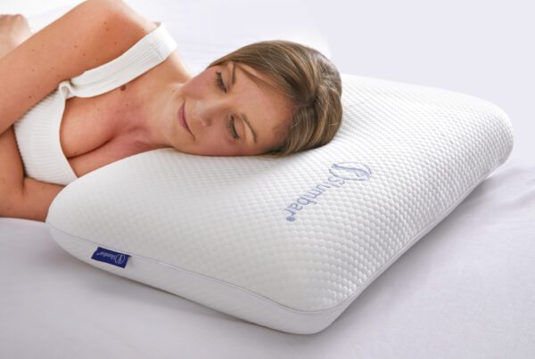 Young Model sleeping on Slumbar Memory foam pillow on a bed